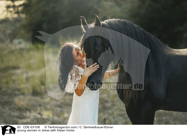 young woman in dress with frisian horse / CDE-03108