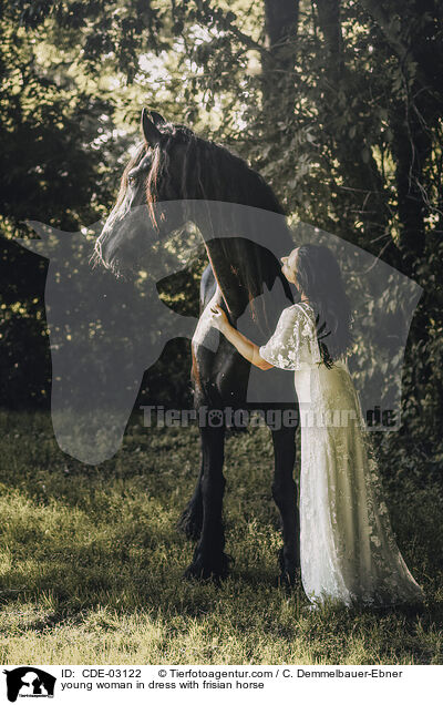 young woman in dress with frisian horse / CDE-03122
