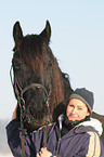 young woman with Frisian horse