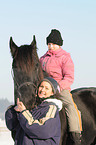 young woman with Frisian horse