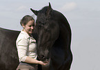 woman and frisian horse