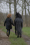 woman and Frisian horse