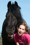 girl and Friesian horse