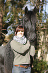 woman and Frisian horse