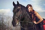 woman rides Frisian horse