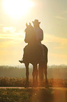 man rides Frisian horse
