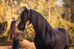 girl and Frisian horse