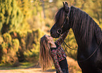 girl and Frisian horse