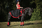 woman rides Friesian Horse