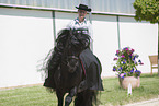 woman rides Friesian horse