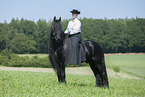 woman rides Friesian horse