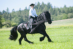 woman rides Friesian horse