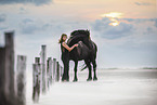 woman and Frisian horse