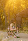 young woman with friesian mare