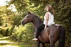 woman rides German Riding Horse