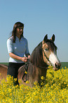 woman rides German Riding Pony