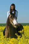 woman rides German Riding Pony