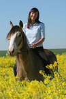 woman rides German Riding Pony