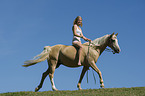 woman rides Pony mare