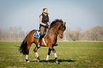 woman rides German Riding Pony