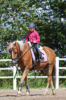 girl rides German Riding Pony