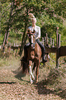 woman rides German Riding Pony