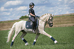 girl rides German Riding Pony