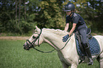 girl rides German Riding Pony