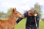 woman and German Riding Pony foals