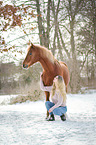 young woman with german riding pony