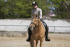 woman rides German Riding Pony