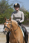 woman rides German Riding Pony