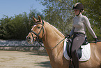 woman rides German Riding Pony