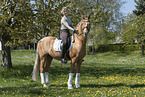 woman rides German Riding Pony