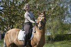 woman rides German Riding Pony