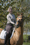 woman rides German Riding Pony