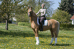 woman rides German Riding Pony