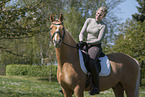 woman rides German Riding Pony