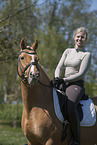 woman rides German Riding Pony