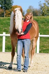 woman and haflinger stallion