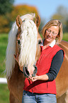 woman and haflinger stallion