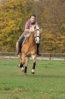 woman rides Haflinger horse