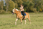 woman rides haflinger horse