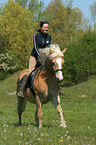woman rides haflinger horse