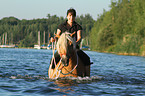 woman rides Haflinger horse