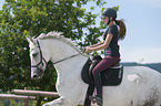 young woman rides Hanoverian Horse