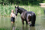 woman with horse in water