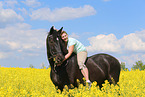 woman rides Heavy Warmblood