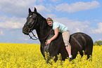 woman rides Heavy Warmblood