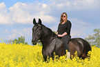 woman rides Heavy Warmblood